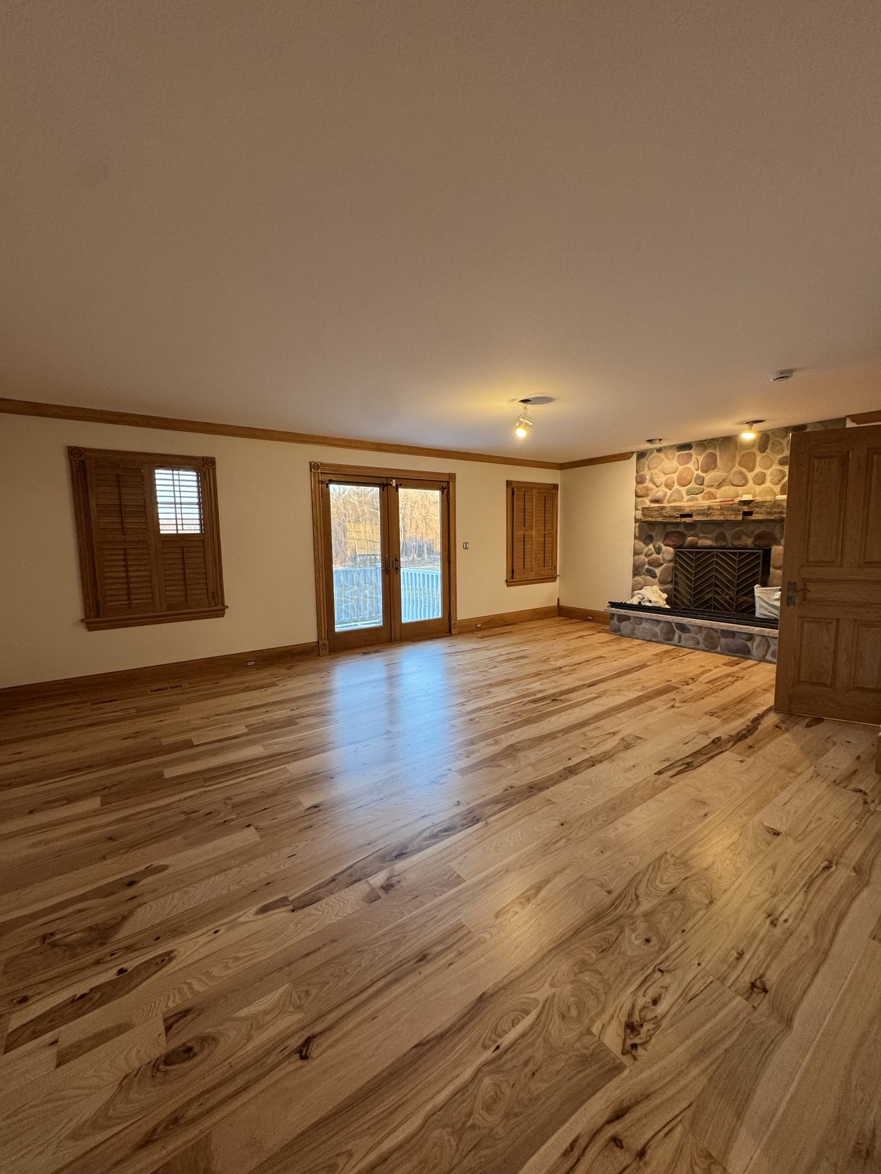 Wide plank hickory living room with stone fireplace