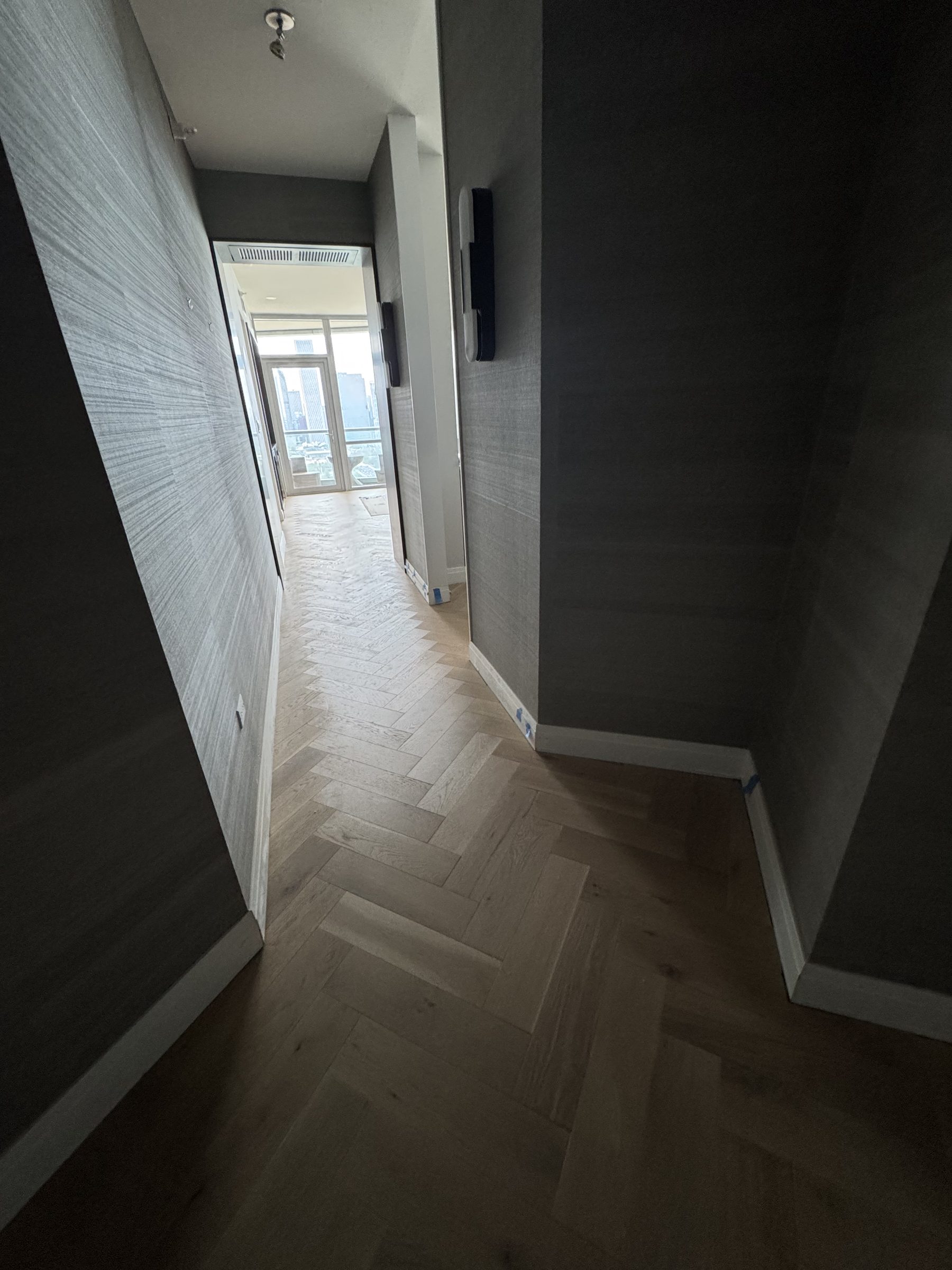 Herringbone hardwood hallway high-rise condominium