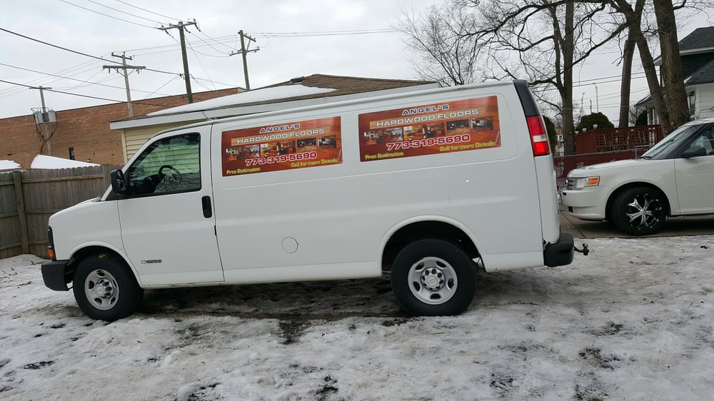Angel's Hardwood Floors work van parked on a snowy residential street